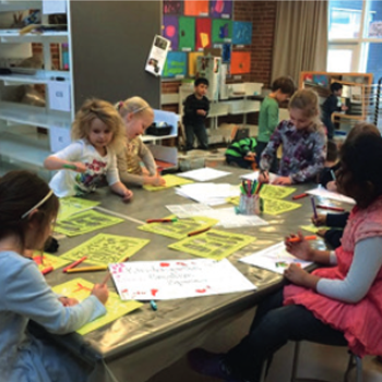 Children drawing at a table.