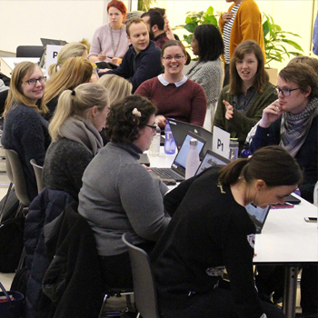 Adults seated around a table at a workshop.