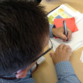 child writing on a post-it