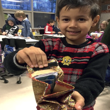 Smiling child showing the result of a craft