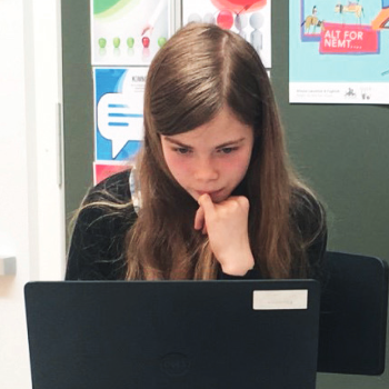 Young girl looking at a computer screen.