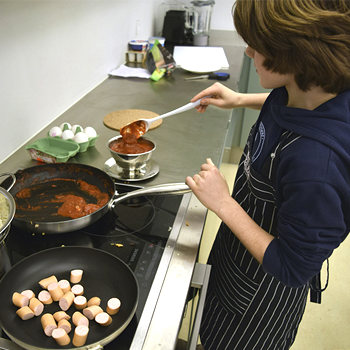 individual cooking in a kitchen