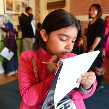 Young girl writing in a notepad