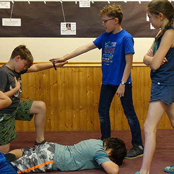 Students standing in various poses.