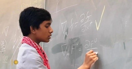 A person writing on a chalk board.